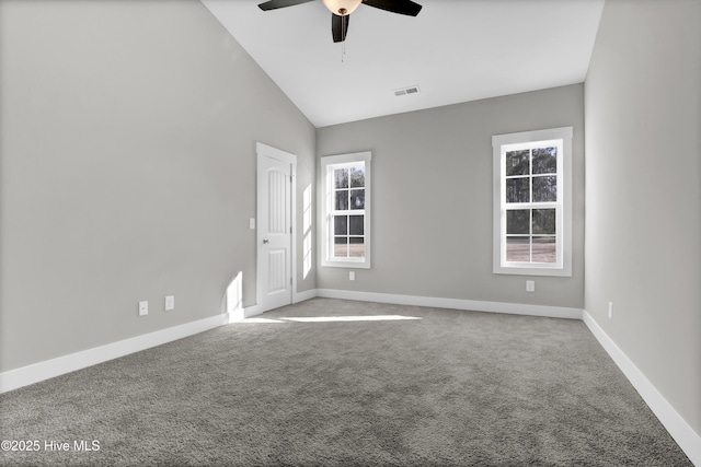 empty room with high vaulted ceiling, light carpet, and ceiling fan