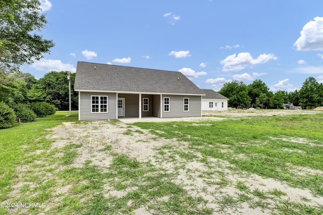 back of house featuring a patio area and a yard