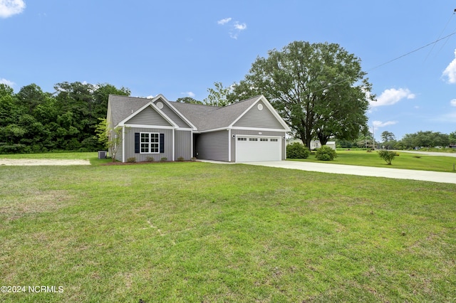 view of front facade with a front yard and a garage