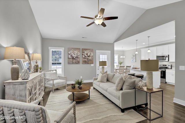 living room featuring lofted ceiling, ceiling fan, and light hardwood / wood-style flooring