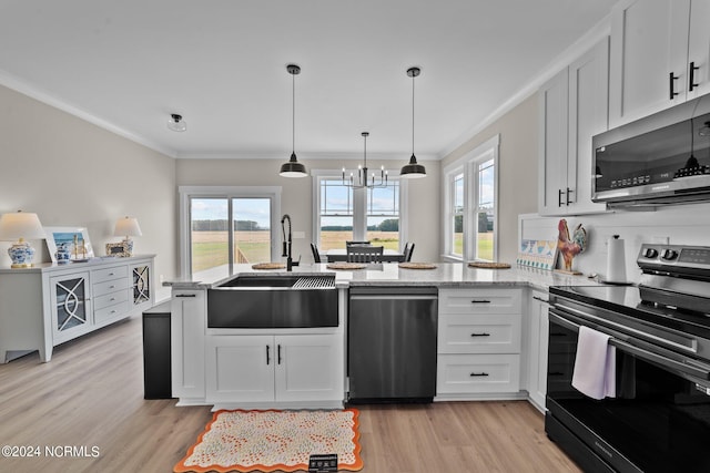 kitchen with sink, light hardwood / wood-style flooring, ornamental molding, appliances with stainless steel finishes, and white cabinetry