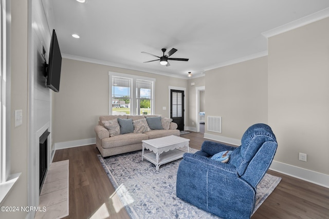 living room with crown molding, hardwood / wood-style floors, and ceiling fan