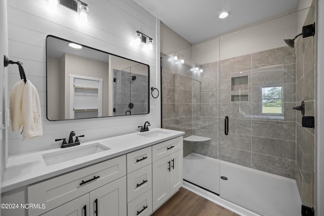 bathroom featuring vanity, wood-type flooring, and walk in shower