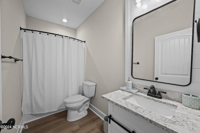 bathroom with vanity, wood-type flooring, and toilet