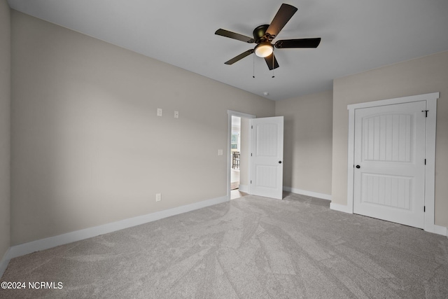 unfurnished bedroom with ceiling fan and light colored carpet