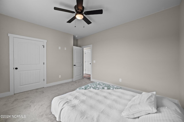 bedroom featuring ceiling fan and light carpet