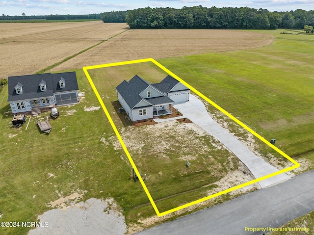 birds eye view of property with a rural view