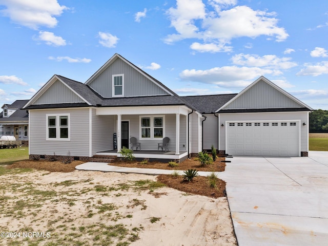 view of front of property featuring a porch and a garage