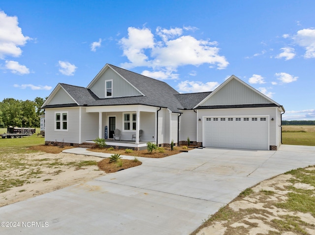 view of front of house featuring a porch and a garage