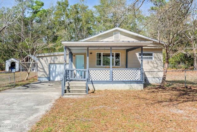 bungalow featuring a garage and a porch