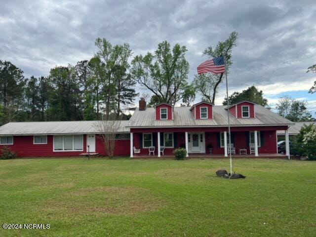 view of front of property with a porch and a front yard