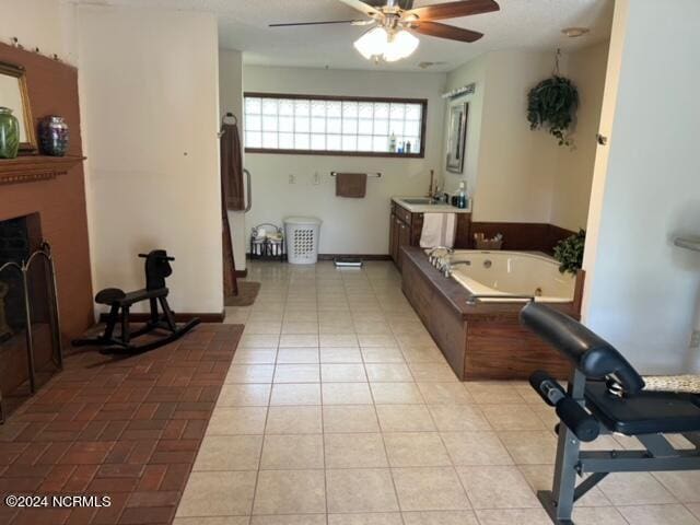 interior space with vanity, tile floors, ceiling fan, and a bath