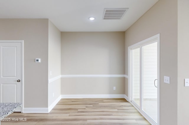 spare room with light hardwood / wood-style floors