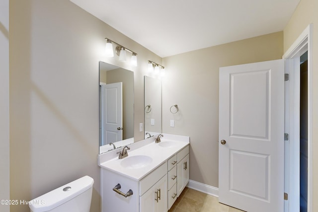 bathroom with tile patterned flooring, vanity, and toilet