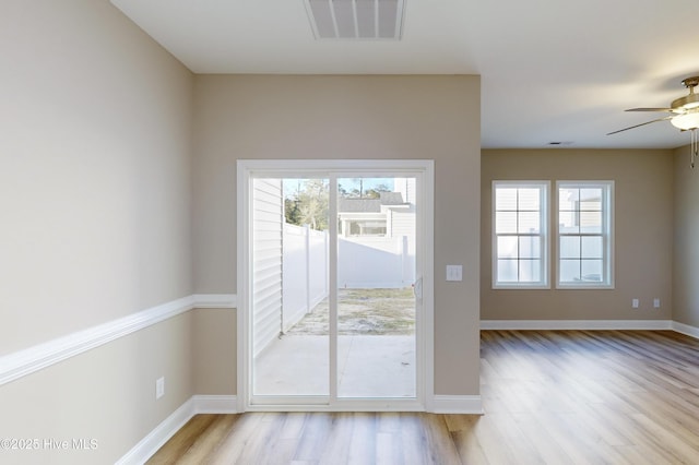 doorway to outside featuring ceiling fan and light hardwood / wood-style floors