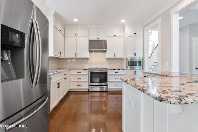 kitchen with white cabinets, stainless steel appliances, and dark hardwood / wood-style floors