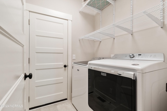 laundry room with washing machine and clothes dryer