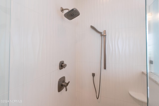 interior details with a tile shower