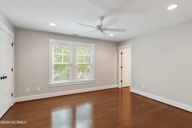 spare room featuring ceiling fan and dark hardwood / wood-style floors