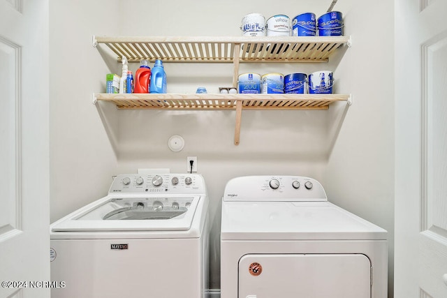 clothes washing area with washer and clothes dryer