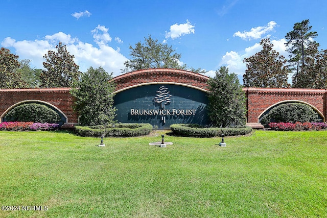 community / neighborhood sign with a lawn