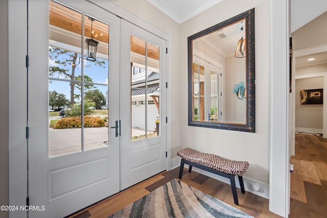 doorway featuring ornamental molding, wood-type flooring, french doors, and a notable chandelier