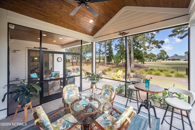 sunroom featuring ceiling fan, wood ceiling, and lofted ceiling