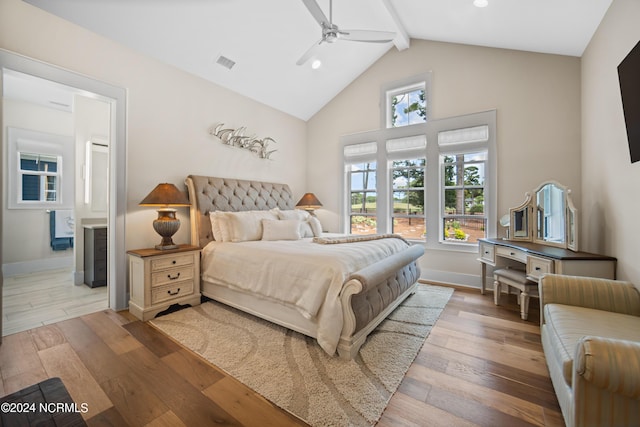 bedroom featuring ceiling fan, lofted ceiling with beams, and hardwood / wood-style flooring