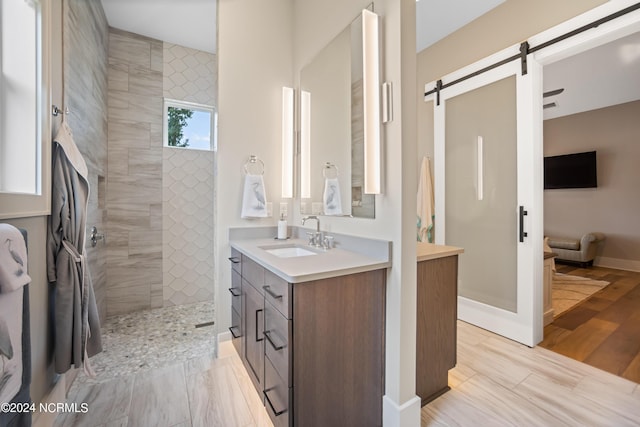 bathroom with vanity and tiled shower