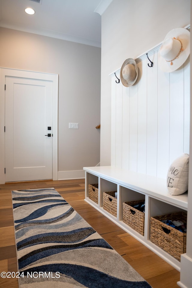 mudroom featuring hardwood / wood-style floors and crown molding