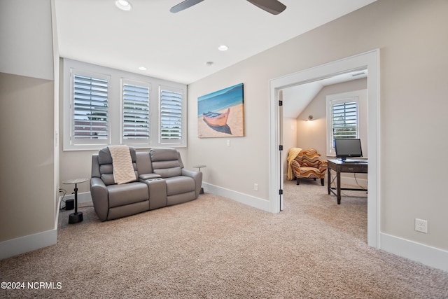 carpeted living room featuring ceiling fan and lofted ceiling