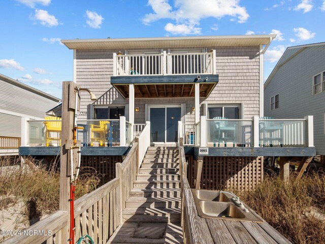 back of property featuring a balcony