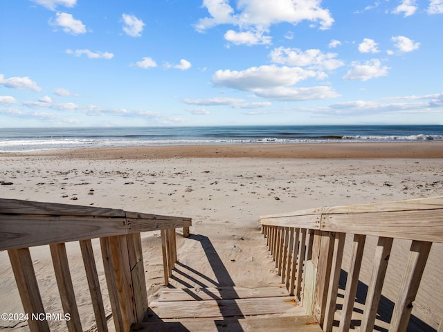 surrounding community with a view of the beach and a water view