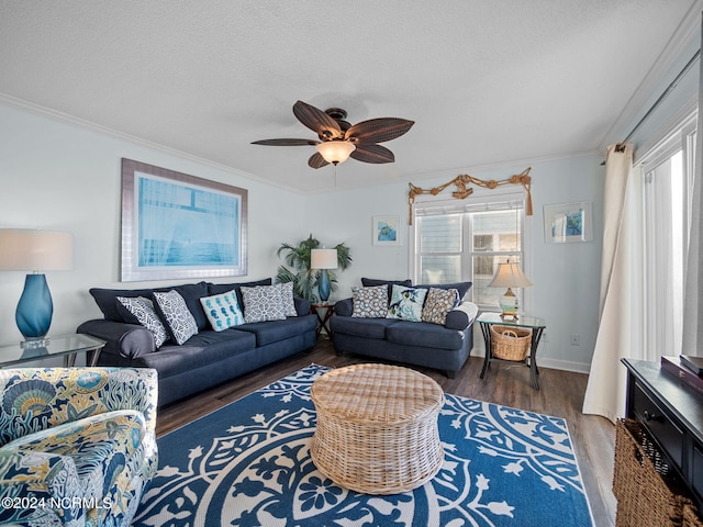 living room featuring ceiling fan, crown molding, dark hardwood / wood-style floors, and a healthy amount of sunlight