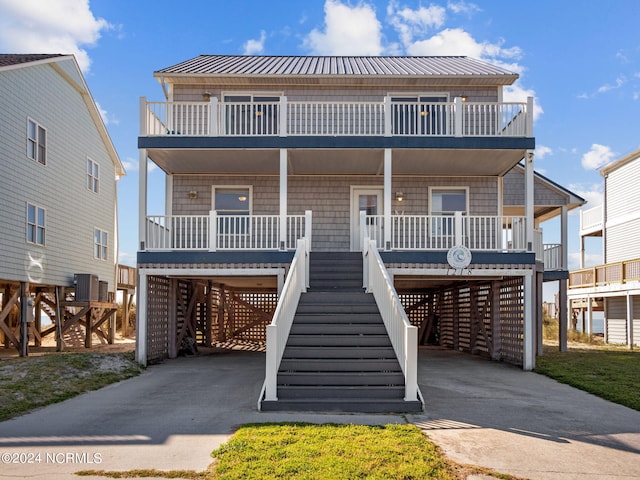 coastal home with a carport and a porch