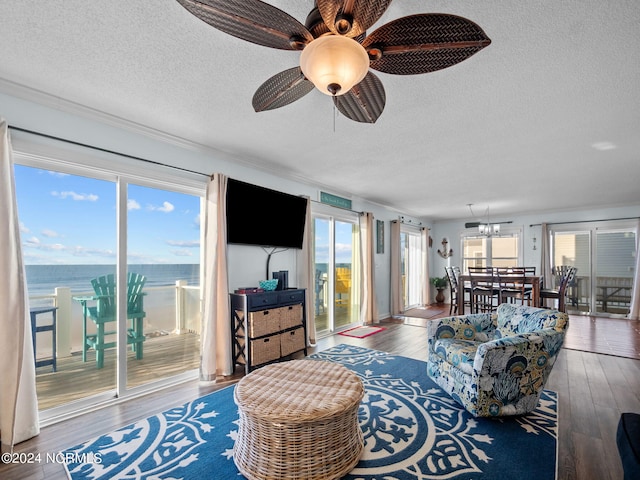 living room featuring hardwood / wood-style floors, ceiling fan, and a healthy amount of sunlight