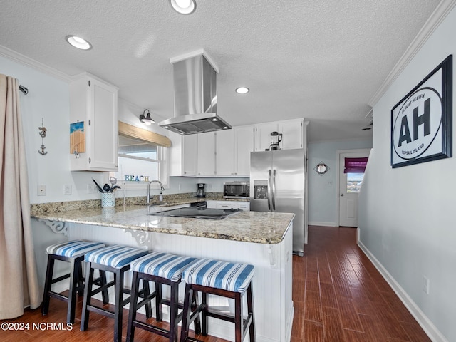 kitchen featuring stainless steel appliances, white cabinetry, light stone countertops, island exhaust hood, and dark hardwood / wood-style flooring