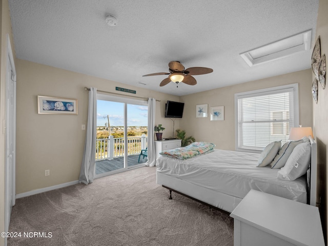 carpeted bedroom featuring a textured ceiling, ceiling fan, and access to exterior