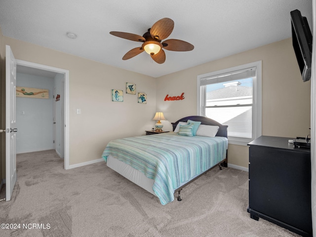 carpeted bedroom featuring ceiling fan