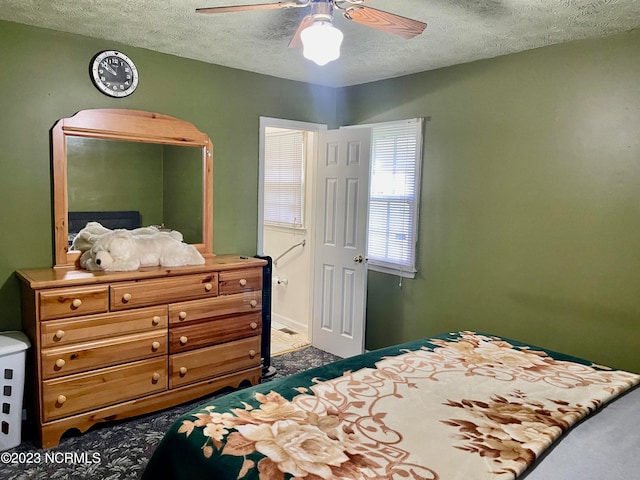 carpeted bedroom with a textured ceiling and ceiling fan