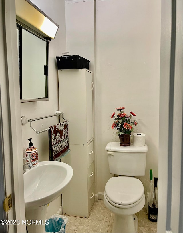 bathroom featuring toilet and tile flooring