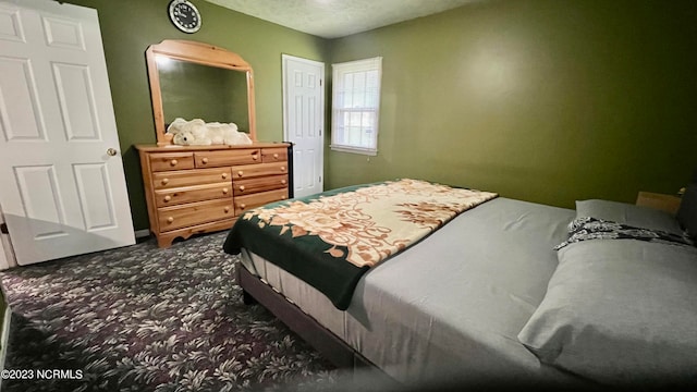 bedroom featuring dark carpet