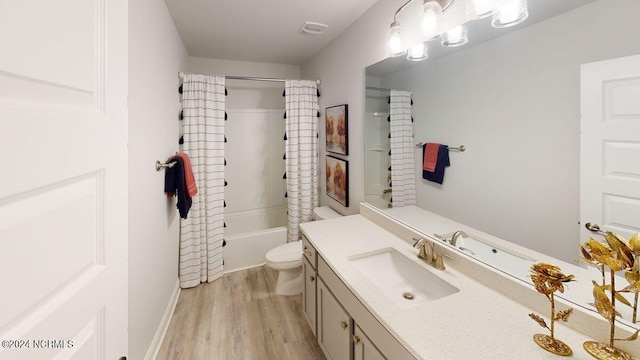 full bathroom with hardwood / wood-style floors, shower / bath combo, vanity, and toilet