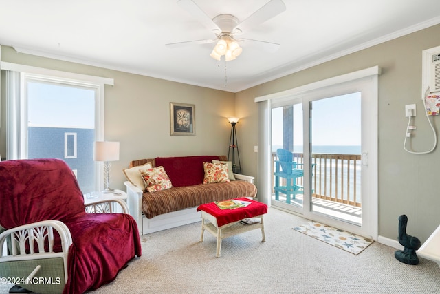 carpeted living room with ornamental molding, ceiling fan, and a water view