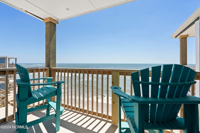 balcony with a beach view and a water view