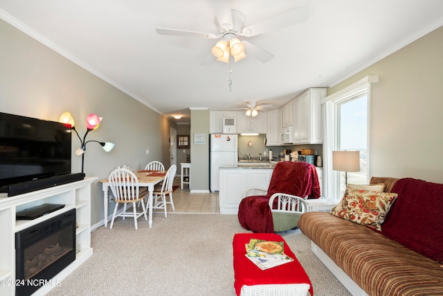 carpeted living room featuring crown molding, sink, and ceiling fan