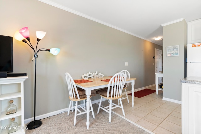 tiled dining area featuring crown molding