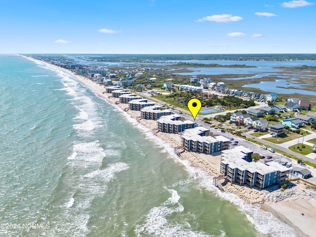 drone / aerial view with a beach view and a water view