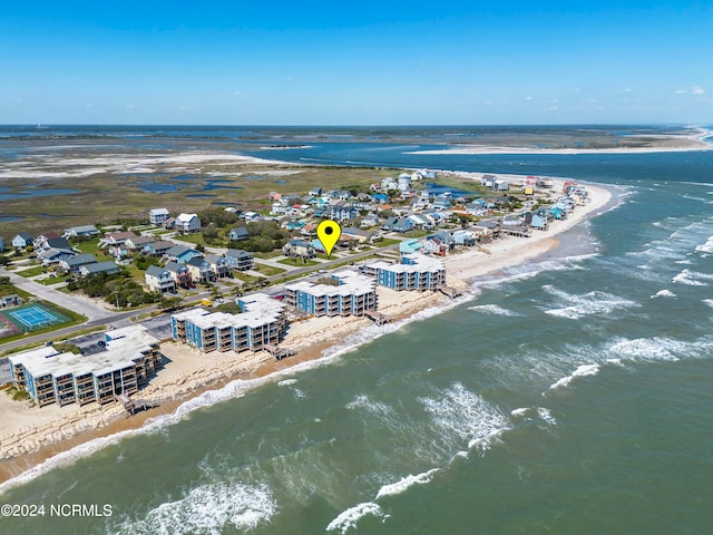 drone / aerial view with a water view and a beach view