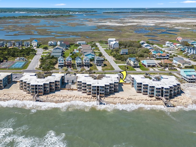 birds eye view of property with a water view and a view of the beach